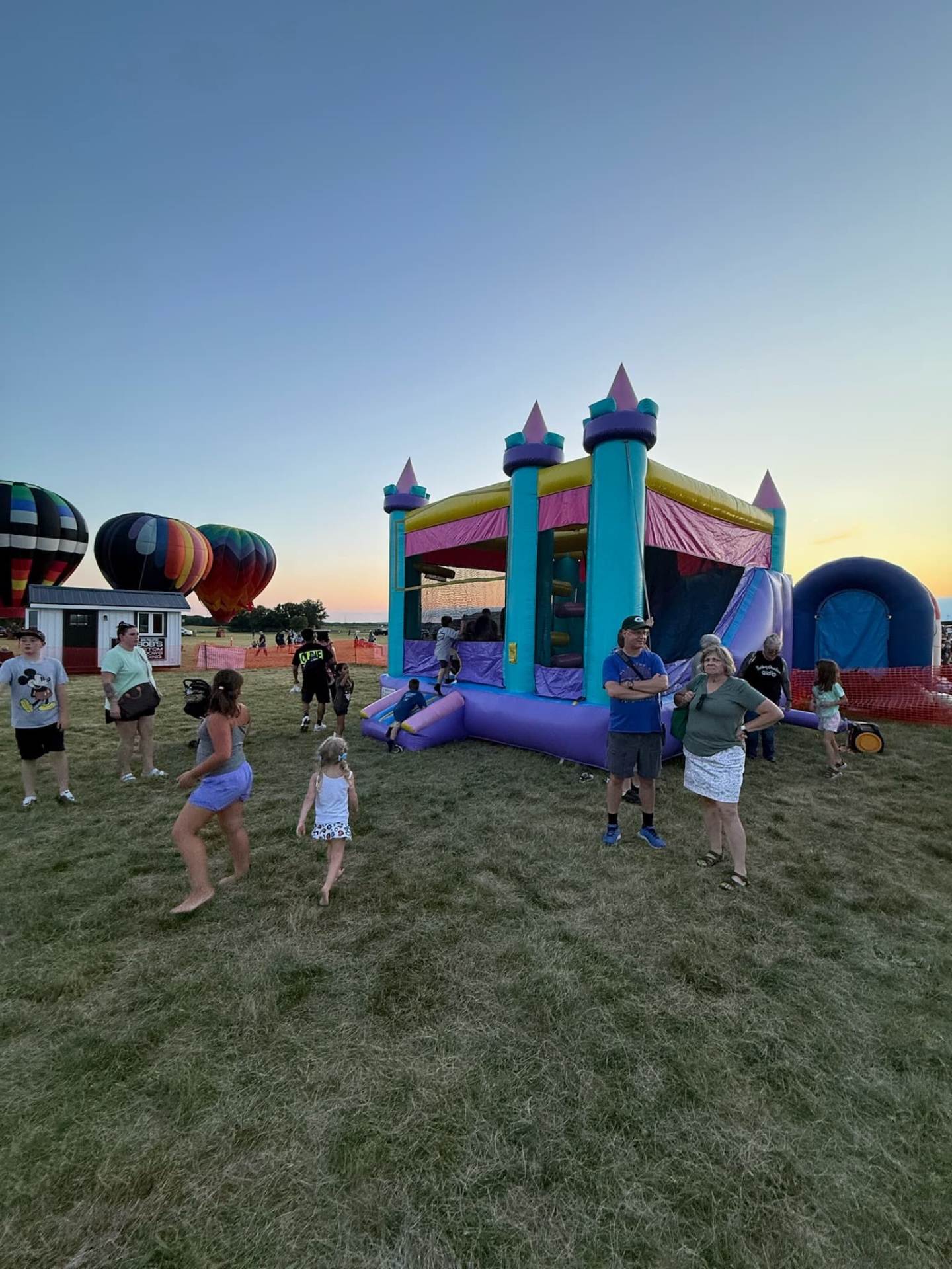 Kids bouncing in bounce houses
