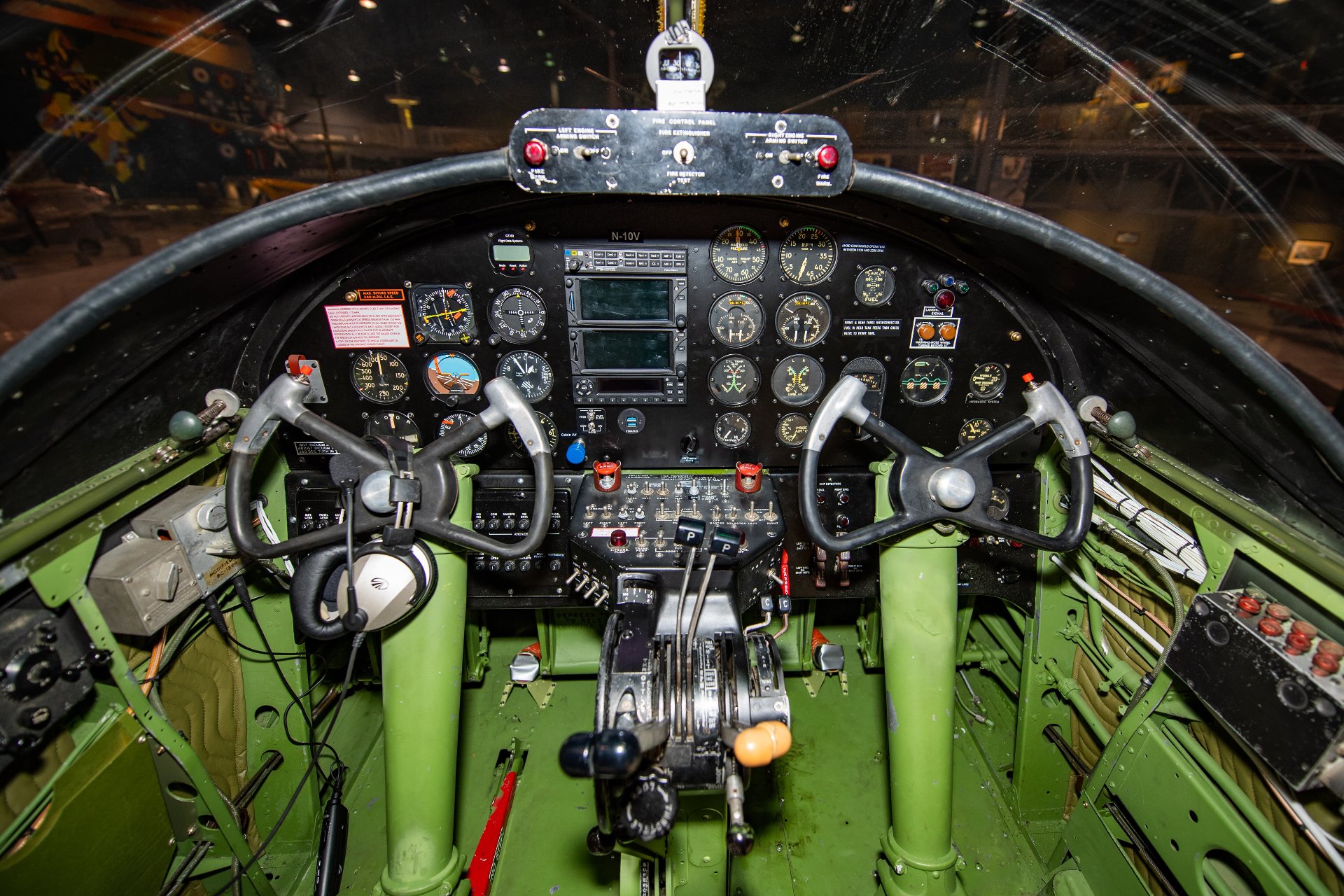 Cockpit interior of a B-25 bomber showing flight controls and instrument panel