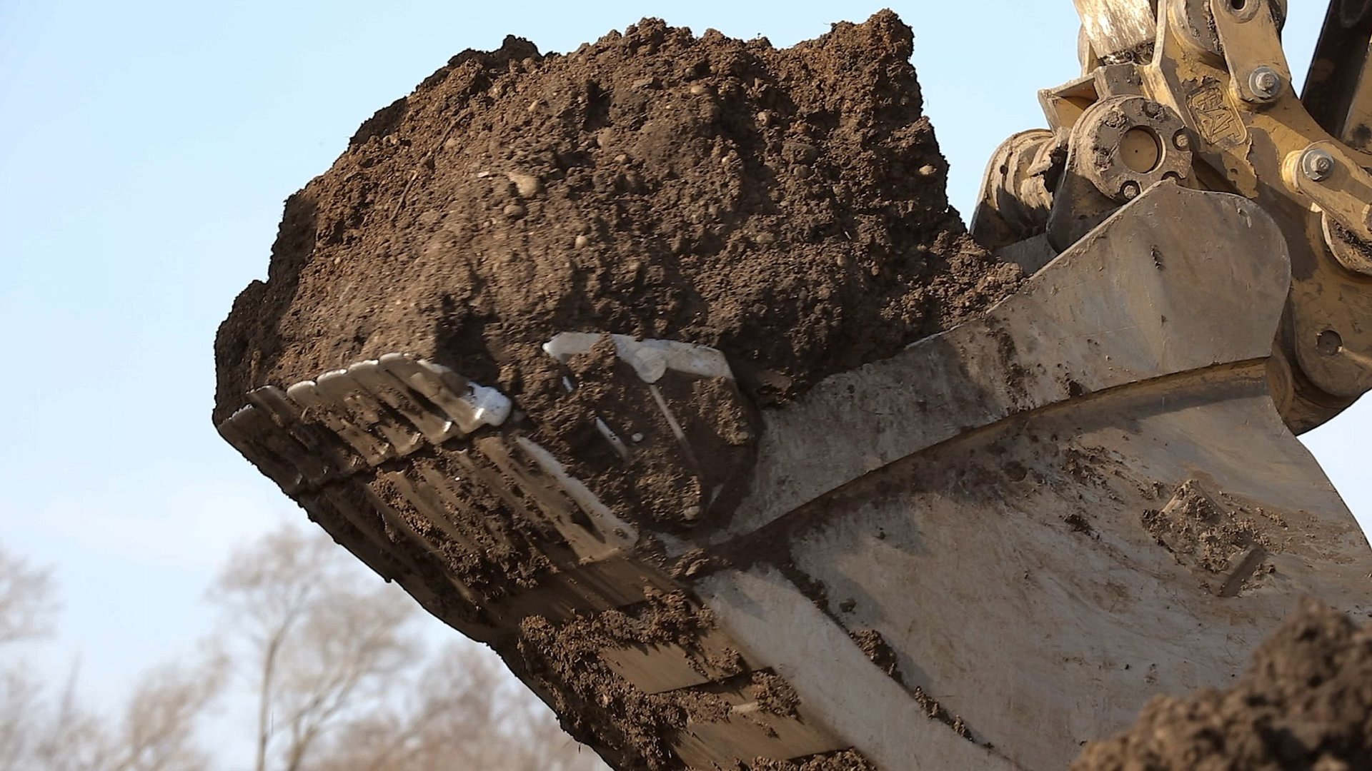 Digger with a scoop of dirt