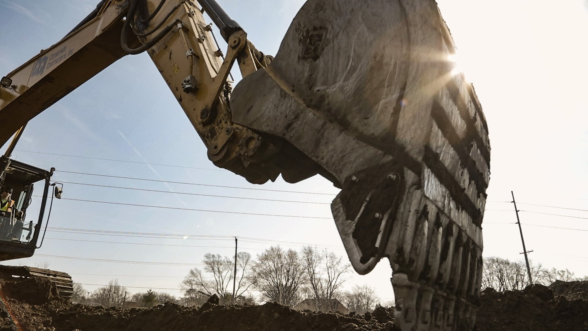 Digger scooping up dirt