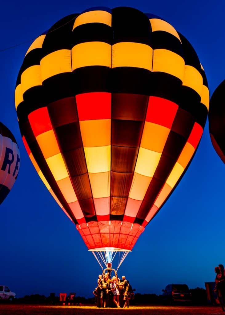 Group of people in the basket of a hot air balloon taking off