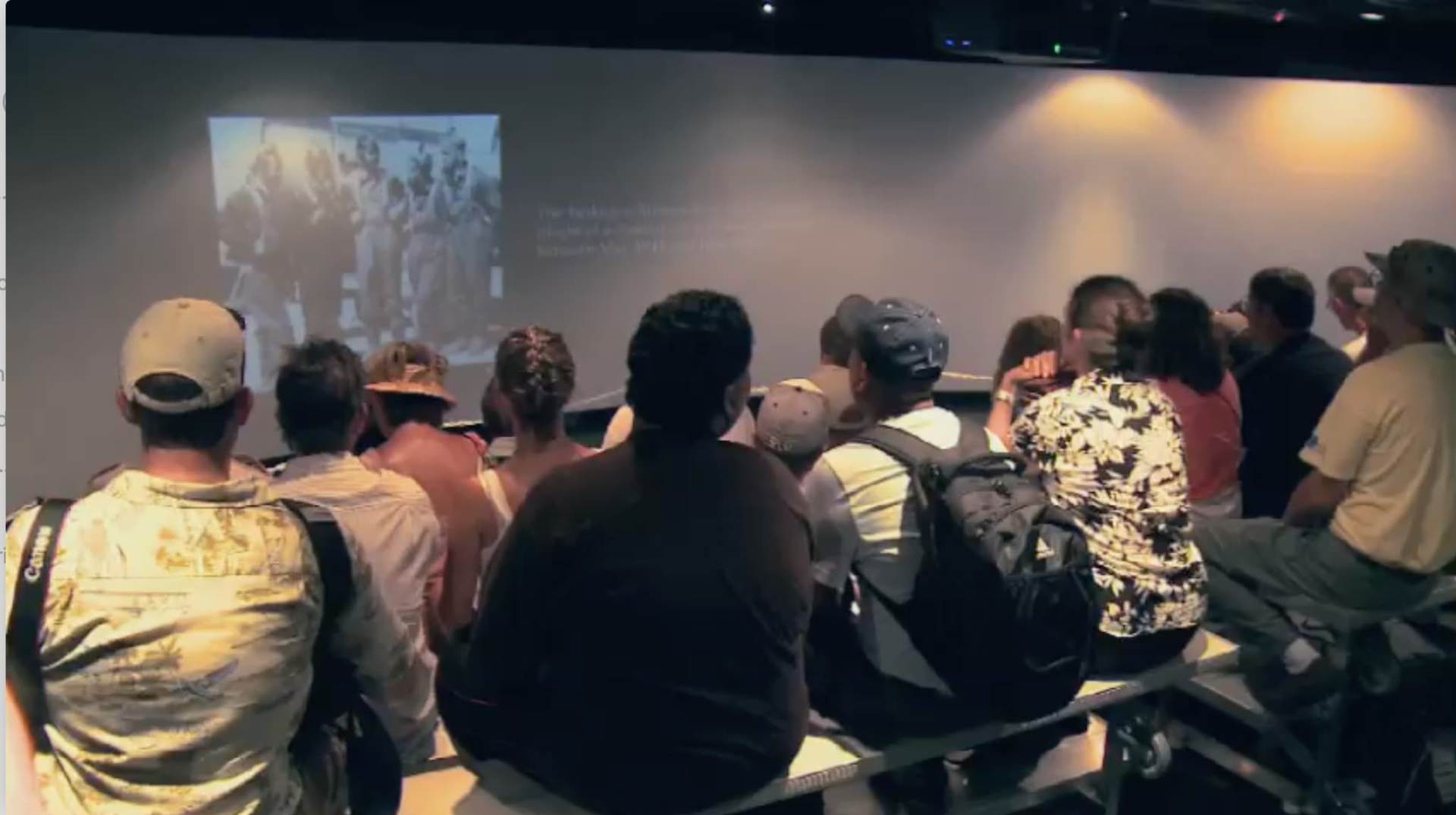 Group of people sitting and watching a movie