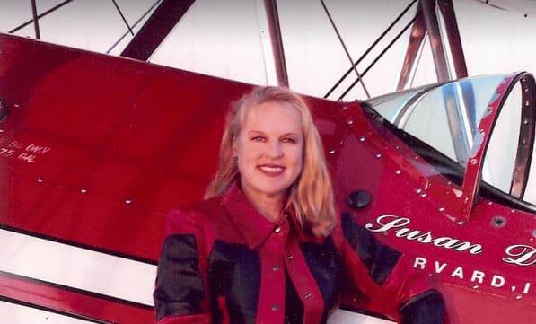 Pilot standing in front of a biplane