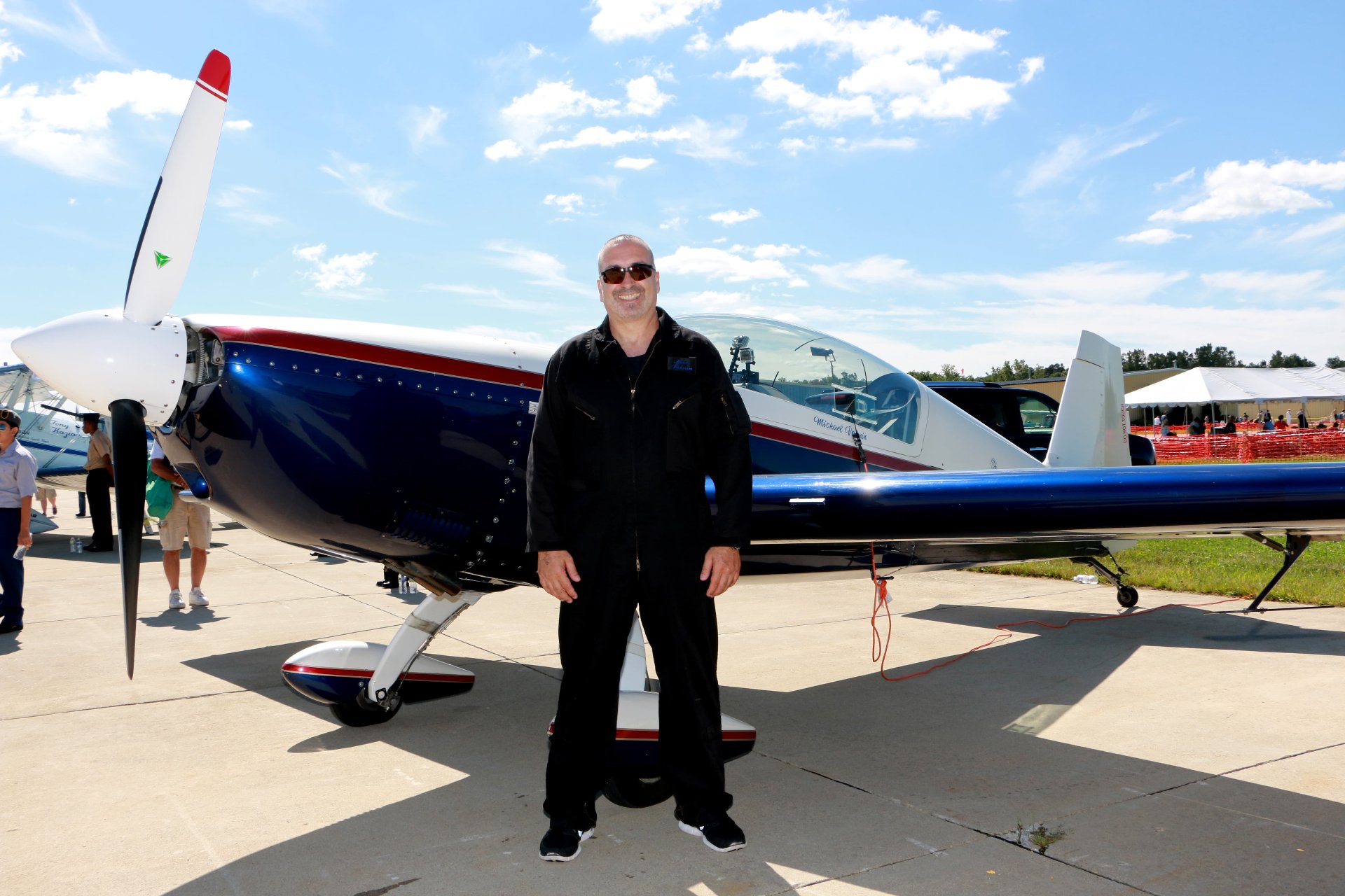 Michael Vaknin stands ouside his plane smiling