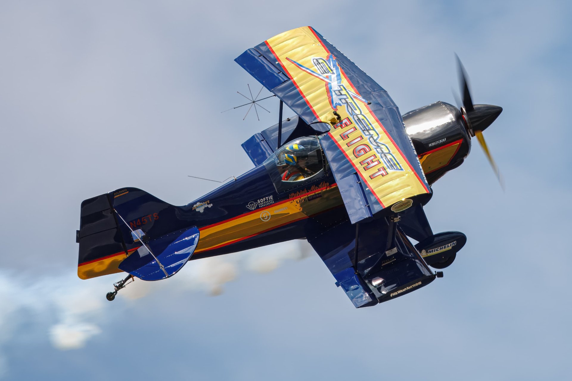 Pitts S-1S aerobatic biplane performing with smoke trails