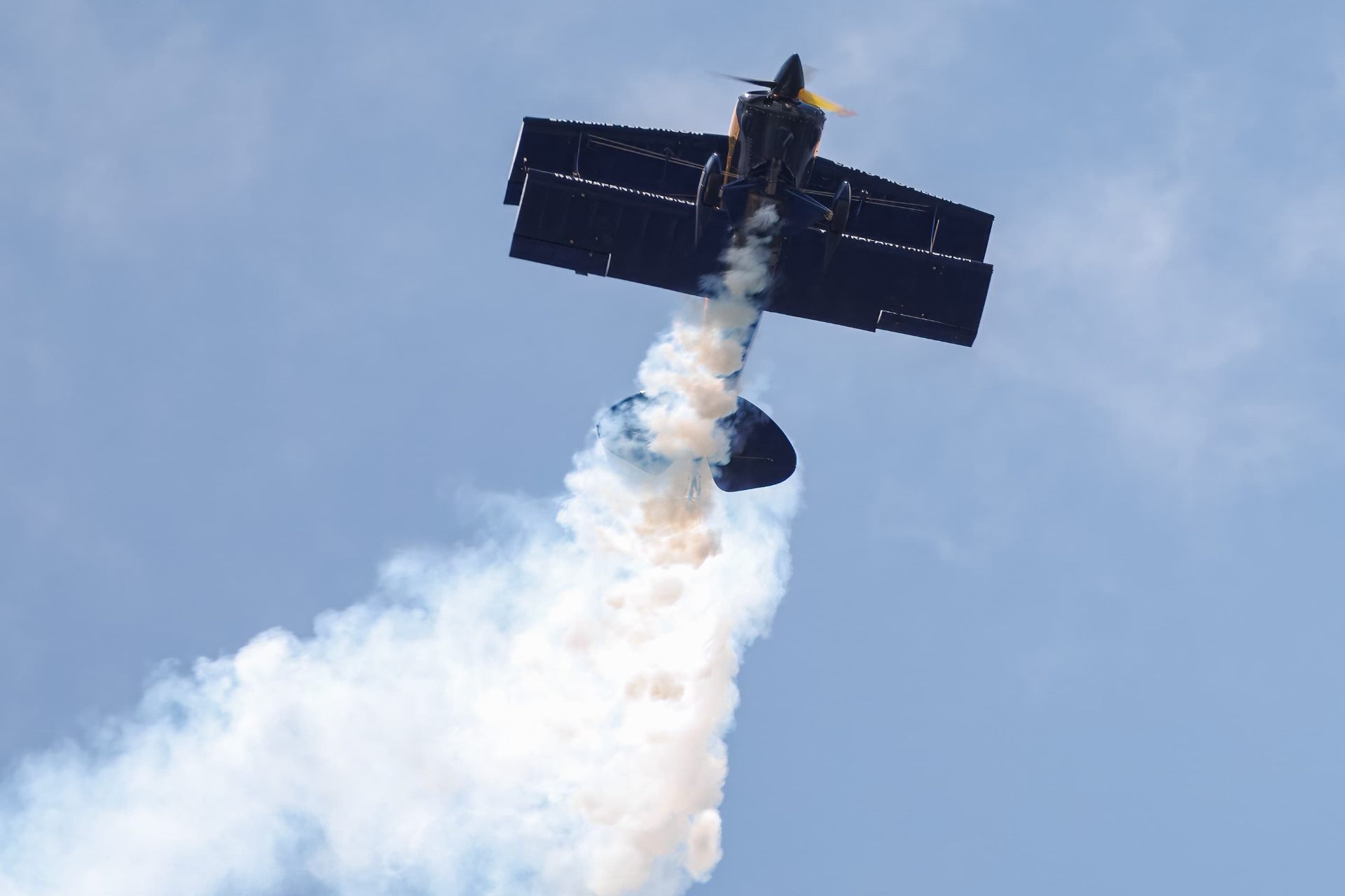 S-1S flying upwards with smoke trailing out the back