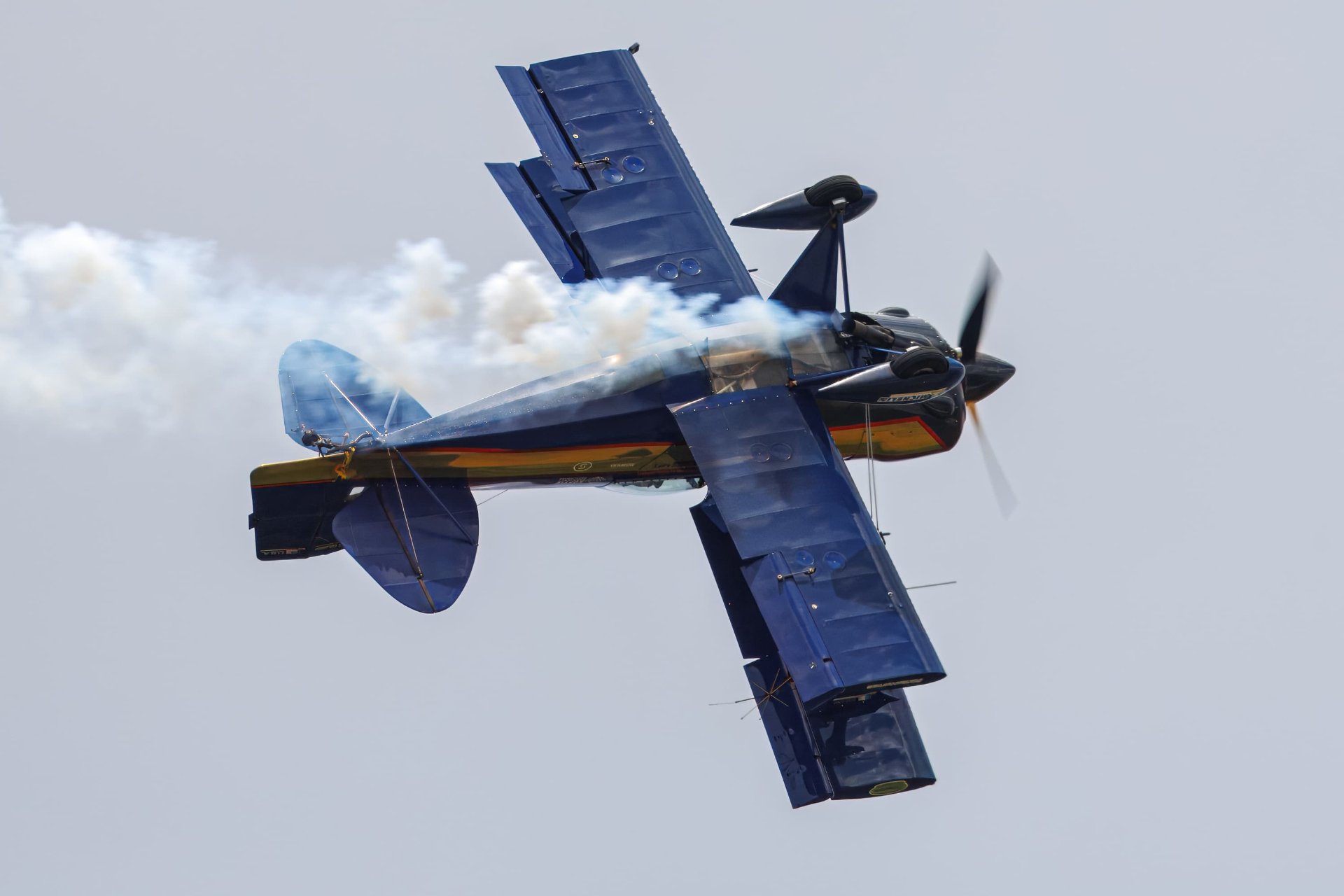 S-1S flying upside down with smoke trailing out the back