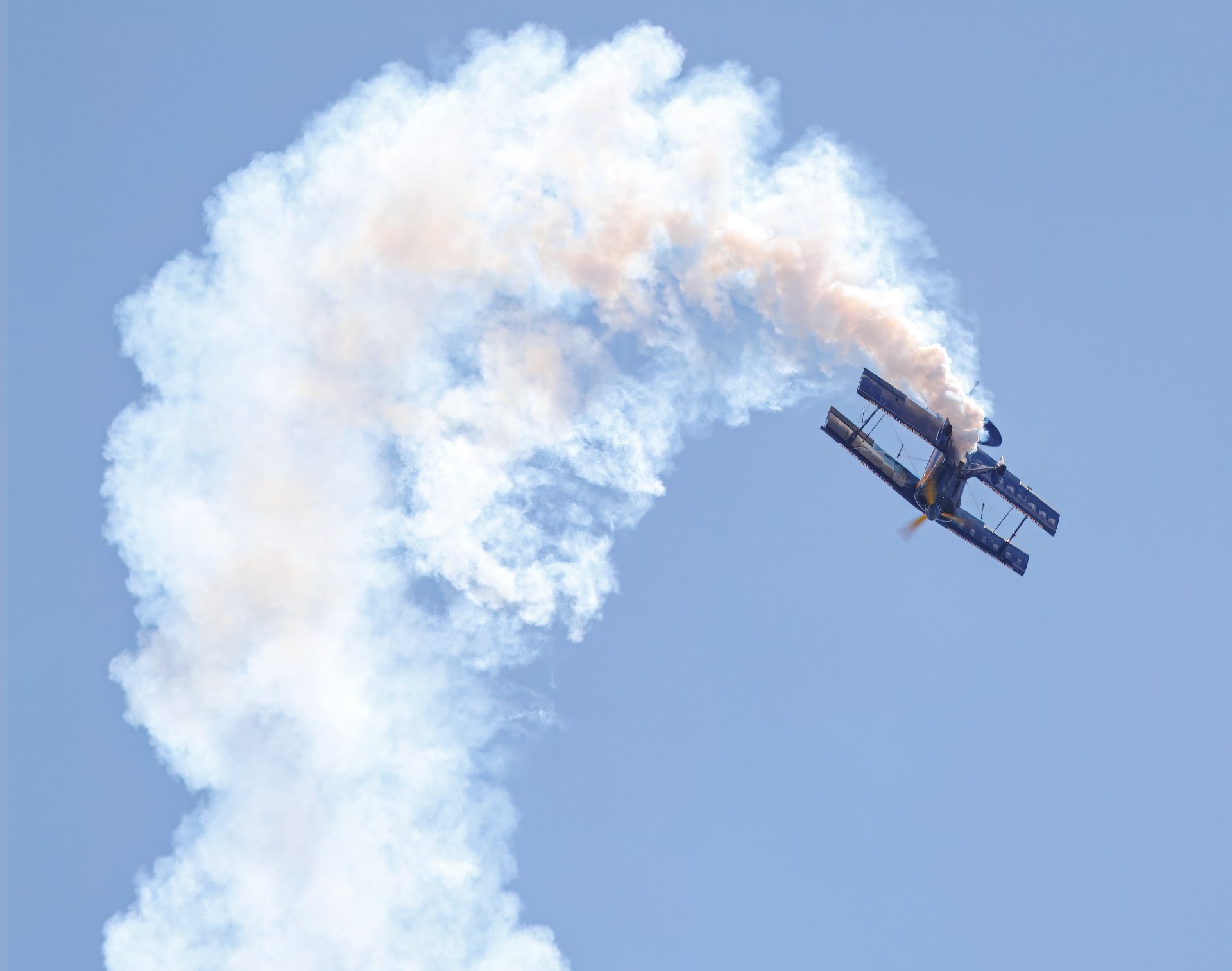 S-1S flying away in a loop with a swirl of smoke behind it