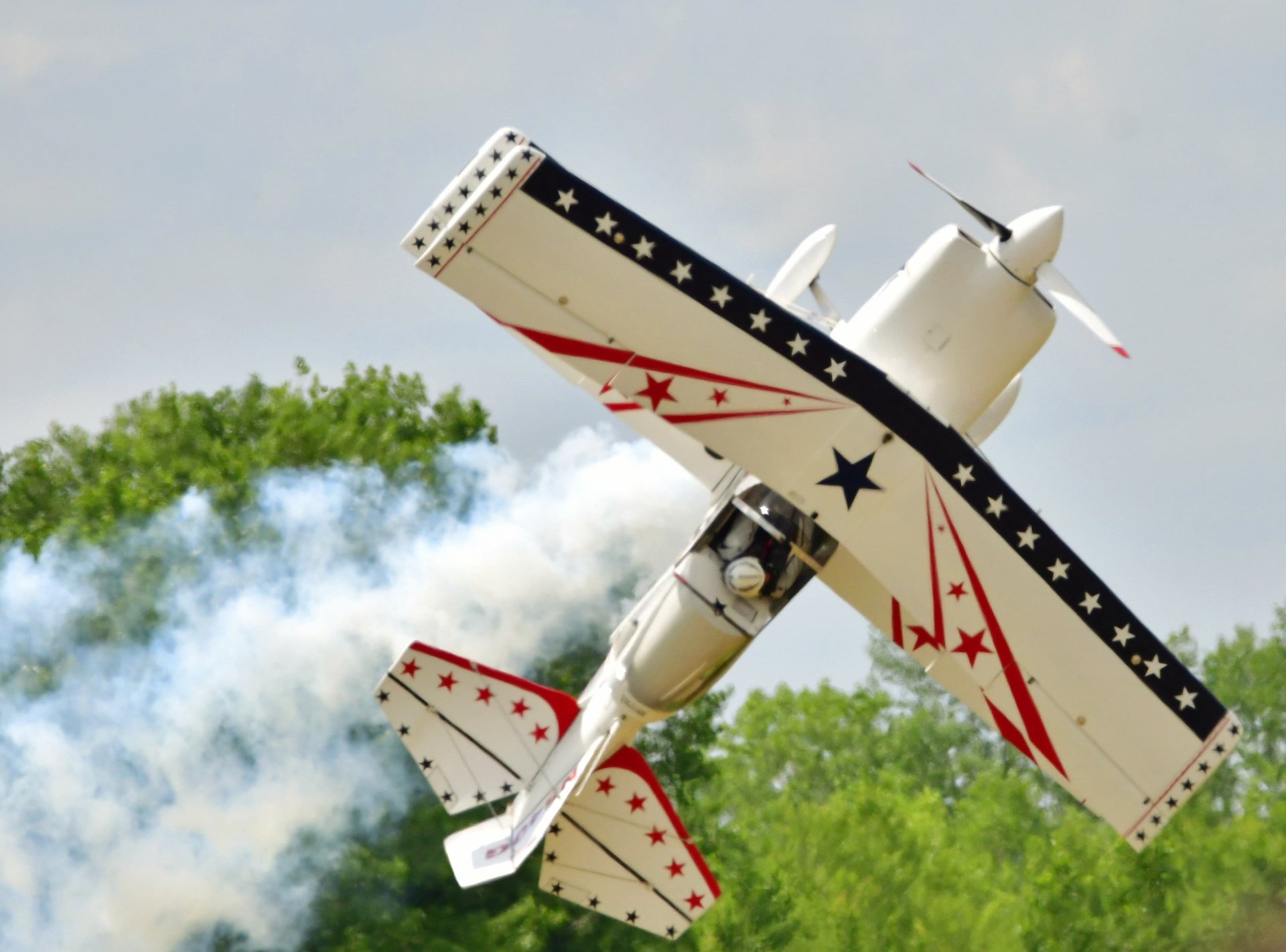 Machaira jet performing a high-speed aerobatic pass with vapor trails